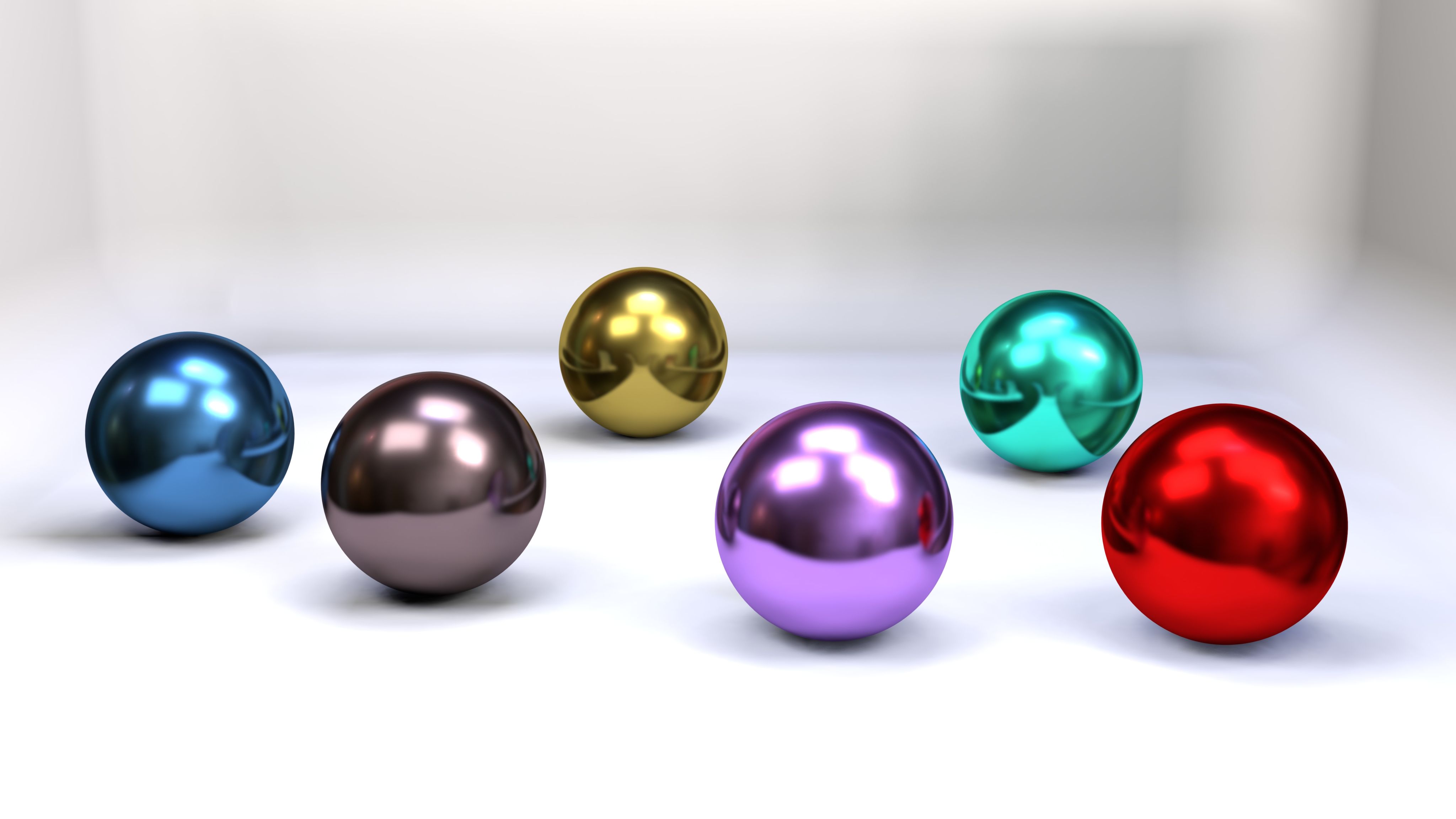a group of shiny balls sitting on top of a white surface