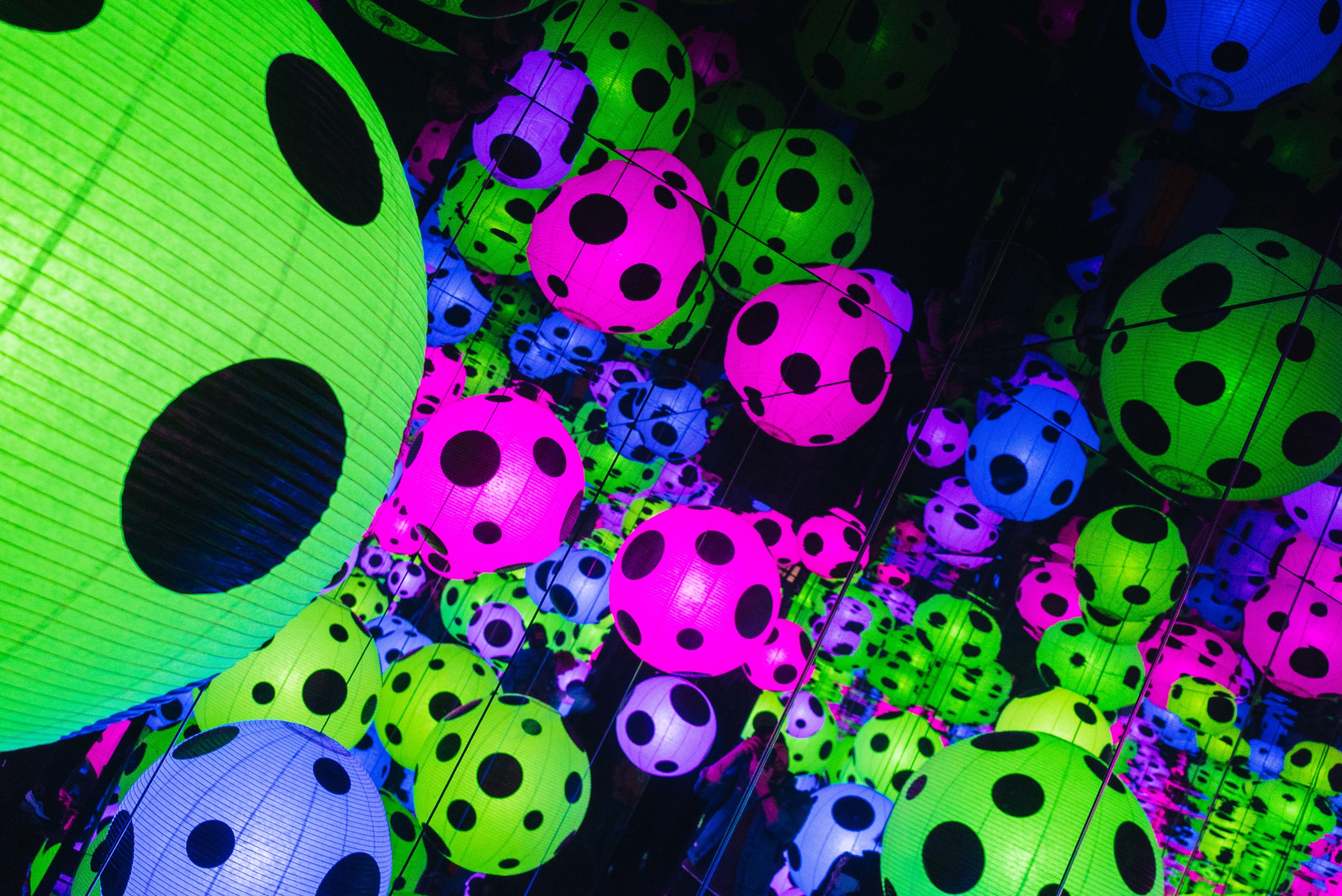 a lot of colorful balls that are in the dark